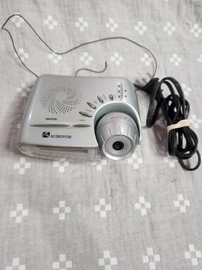 Audiovox AM/FM projection alarm clock radio featuring a silver-tone finish